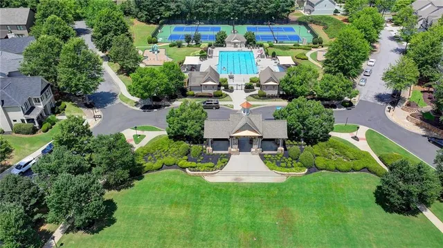 an aerial view of a house with a yard basket ball court and outdoor seating