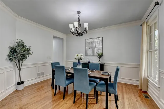 a view of a dining room with furniture window and wooden floor