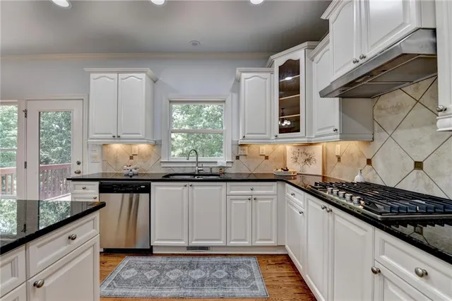 a kitchen with granite countertop a sink and a stove