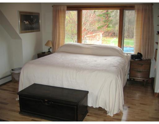 466 Warren Wright Road Belchertown, MA 01007 - Photo 7 of 10 a bedroom with a bed and a large window