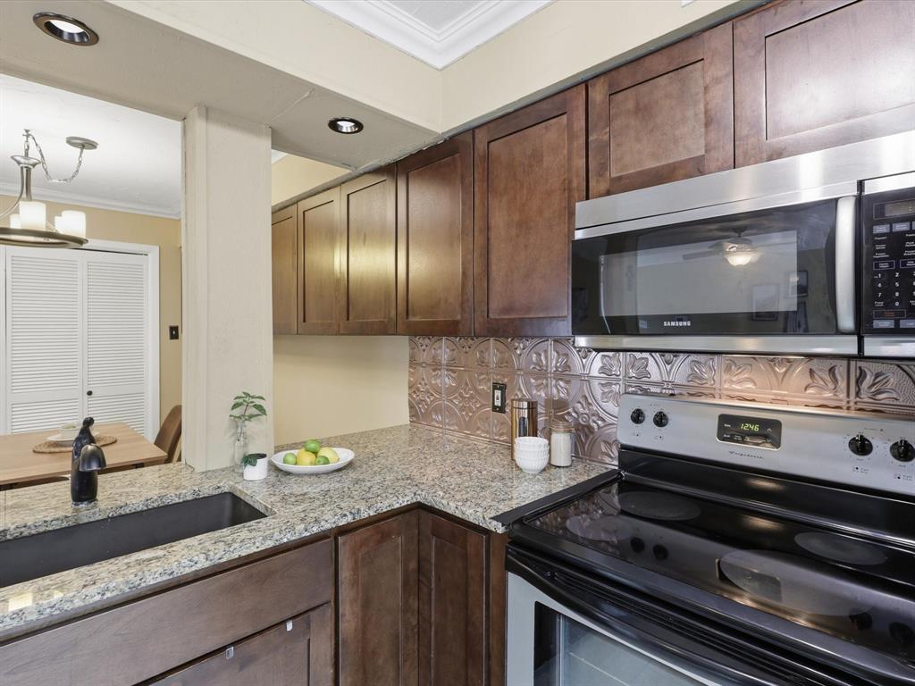4250 Madera Road Irving, TX 75038 - Photo 12 of 31 a kitchen with stainless steel appliances and cabinets