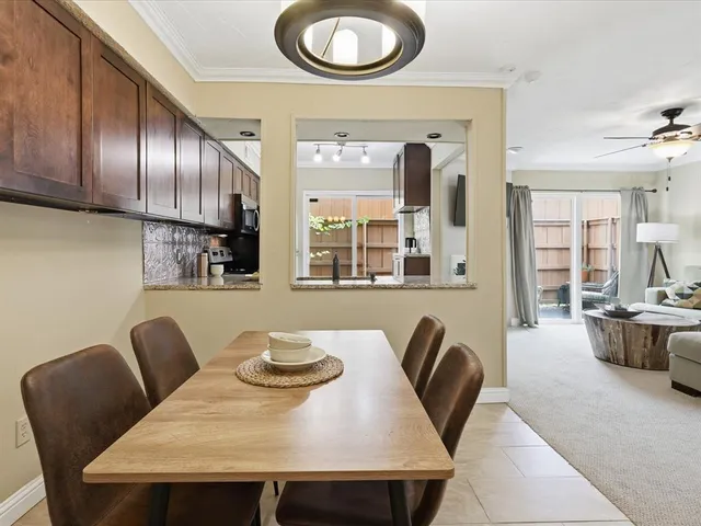a view of a dining room with furniture a couch and wooden floor
