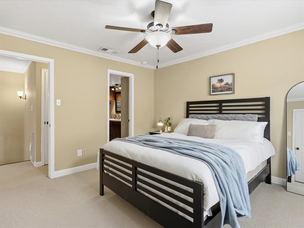 4250 Madera Road Irving, TX 75038 - Photo 21 of 31 a bedroom with a bed and a chandelier