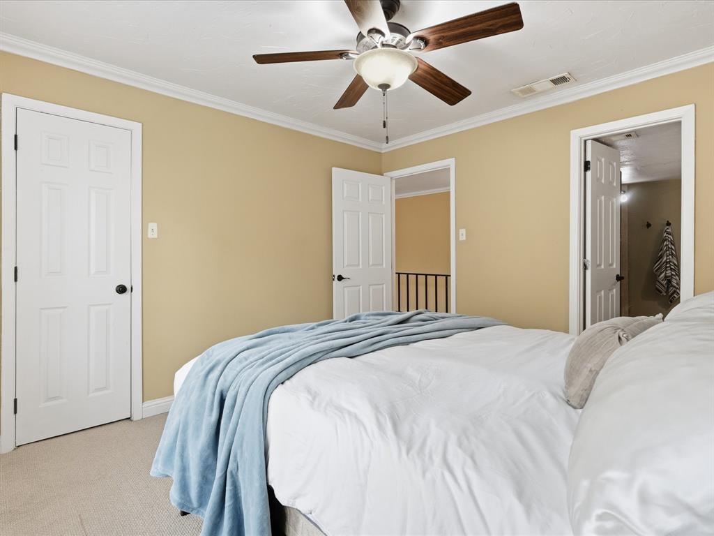 4250 Madera Road Irving, TX 75038 - Photo 22 of 31 a bedroom with a bed and a chandelier