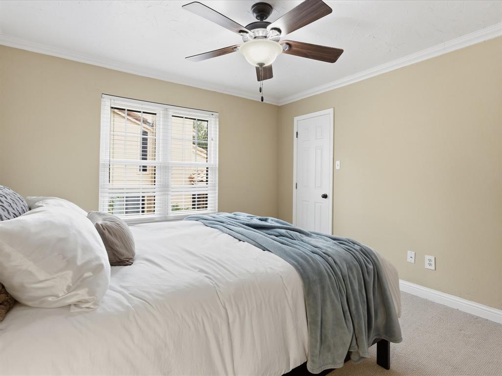 4250 Madera Road Irving, TX 75038 - Photo 23 of 31 a bedroom with a bed and a large window