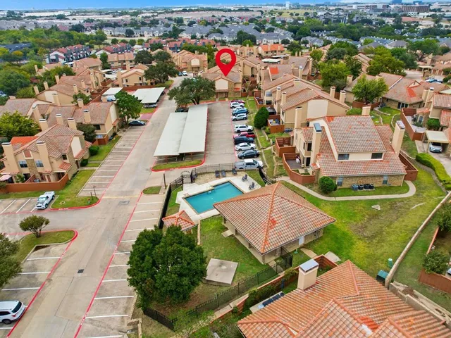 an aerial view of a house with a garden and lake view