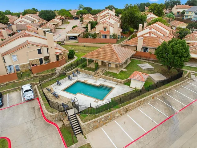 an aerial view of residential houses with outdoor space