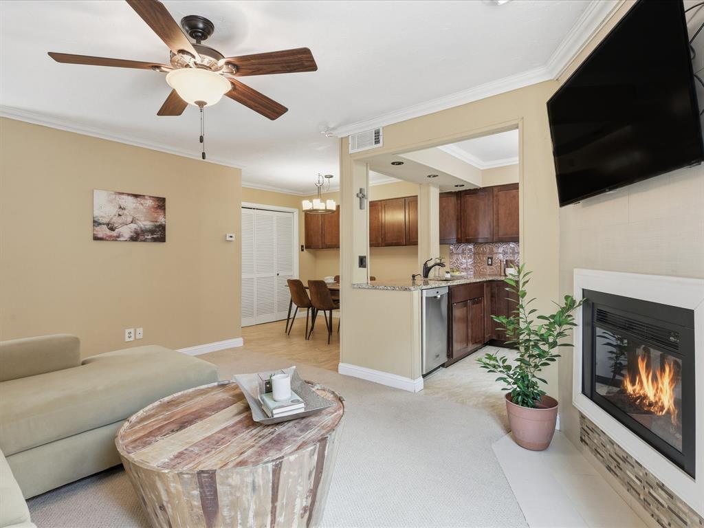 4250 Madera Road Irving, TX 75038 - Photo 8 of 31 a living room with furniture a flat screen tv and kitchen view
