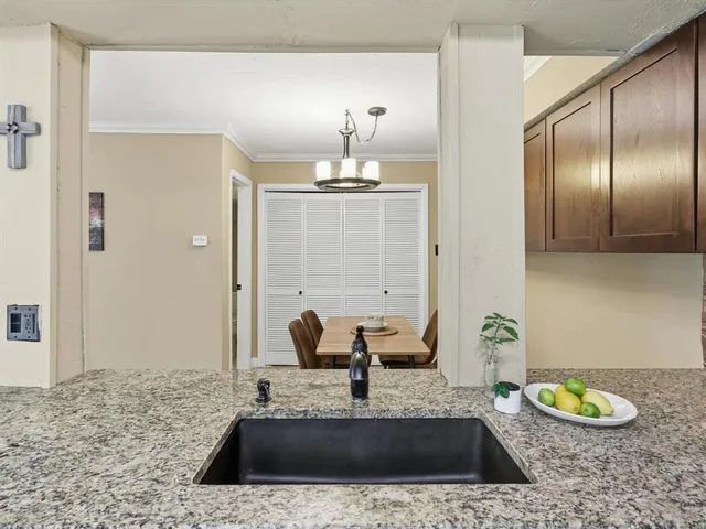 a spacious bathroom with a granite countertop sink and a mirror