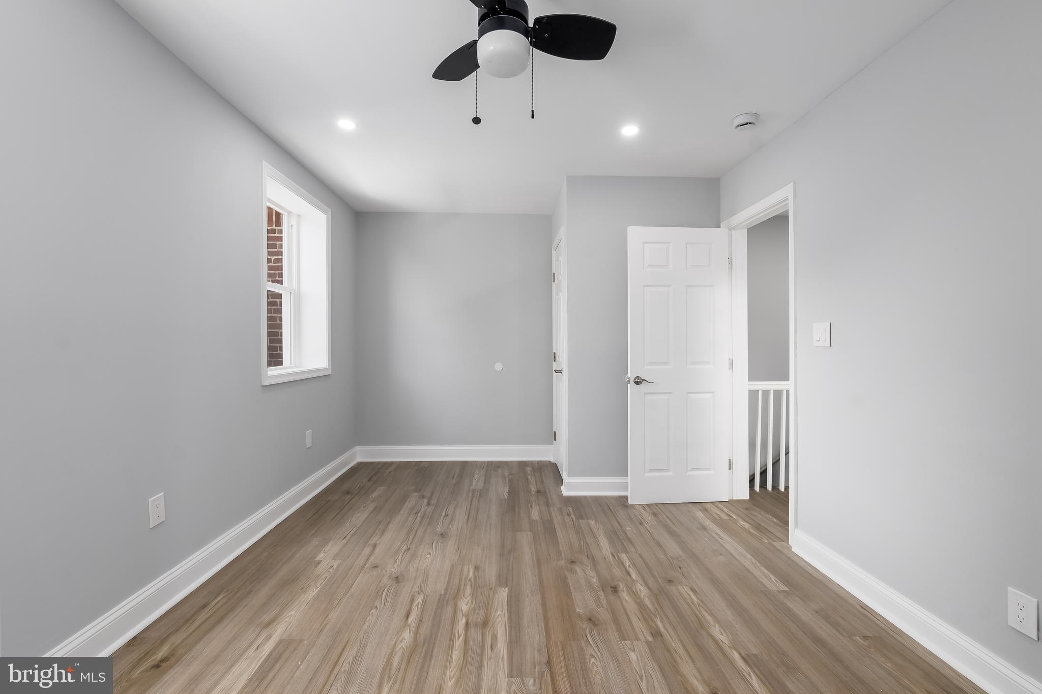 1401 18th Place Southeast Washington, DC 20020 - Photo 17 of 38 an empty room with wooden floor and windows