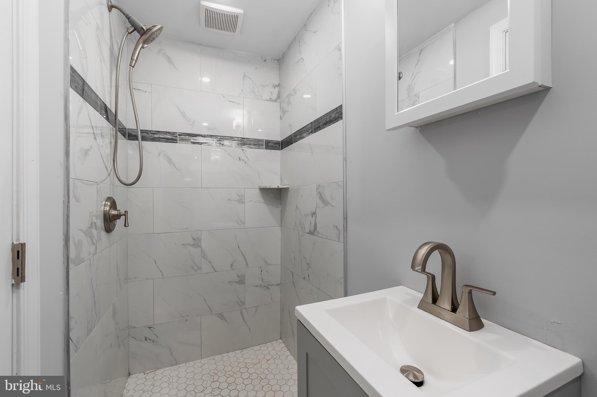 1401 18th Place Southeast Washington, DC 20020 - Photo 33 of 38 a bathroom with a sink and a mirror