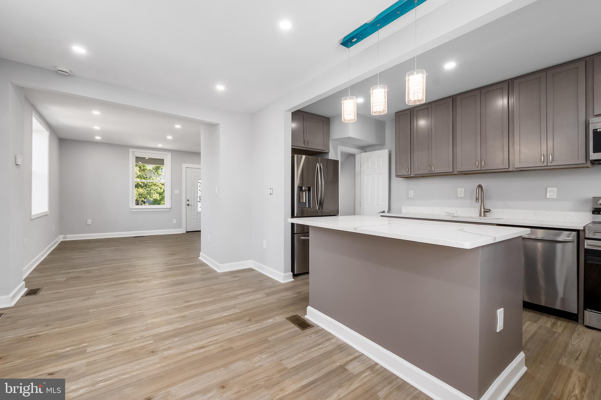 1401 18th Place Southeast Washington, DC 20020 - Photo 8 of 38 a kitchen with stainless steel appliances granite countertop a sink refrigerator and microwave