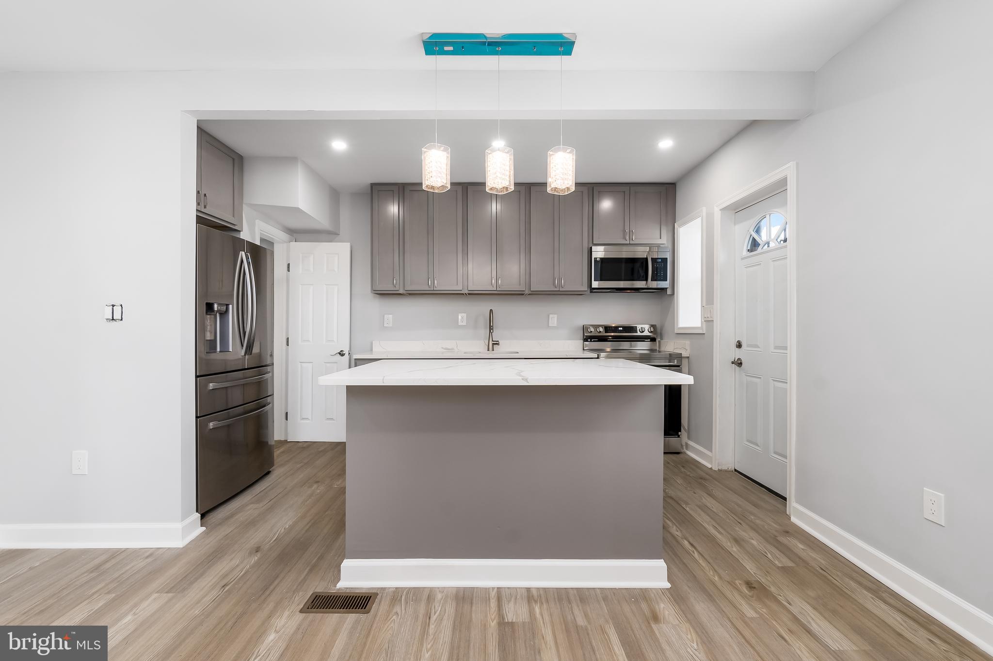 1401 18th Place Southeast Washington, DC 20020 - Photo 10 of 38 a kitchen with a refrigerator and a stove top oven