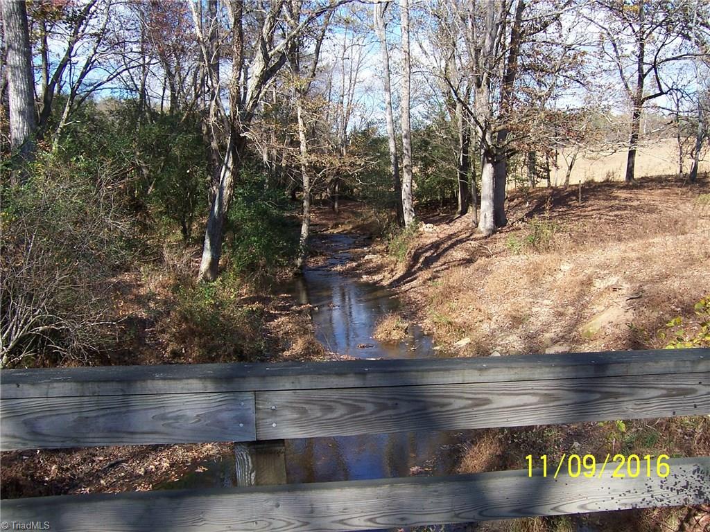 0 Gentry Road Elkin, NC 28621 - Photo 25 of 30 This view is looking over the railing along the road. The Little Elkin Creek flows through the property for about 2700 ft. to the upper end.