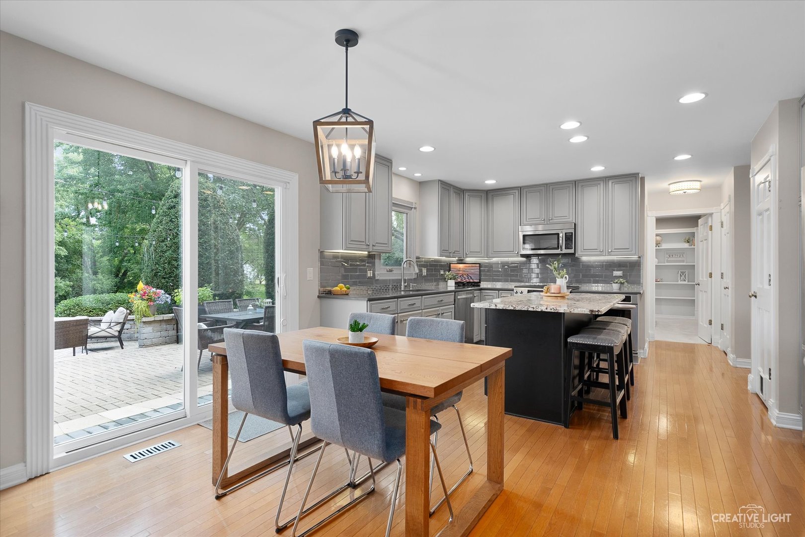409 Flock Avenue Naperville, IL 60565 - Photo 12 of 48 a view of a dining room and livingroom with furniture wooden floor a chandelier