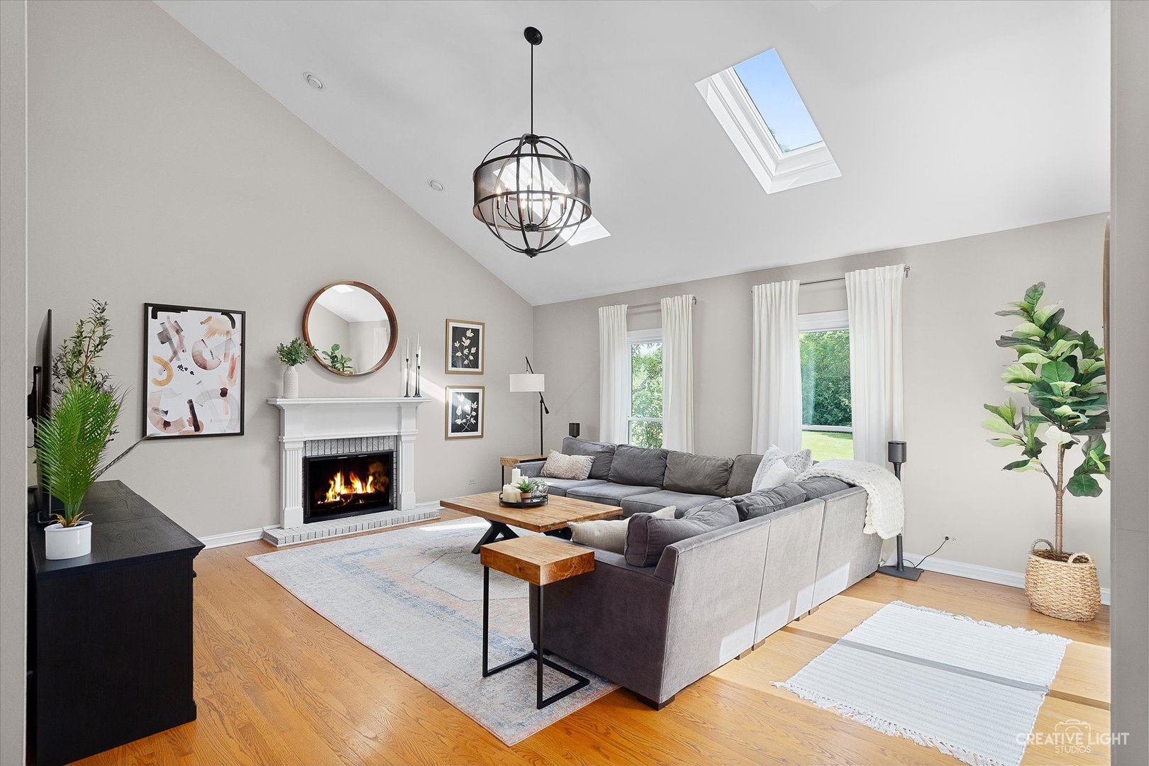409 Flock Avenue Naperville, IL 60565 - Photo 13 of 48 a living room with furniture a fireplace and a potted plant