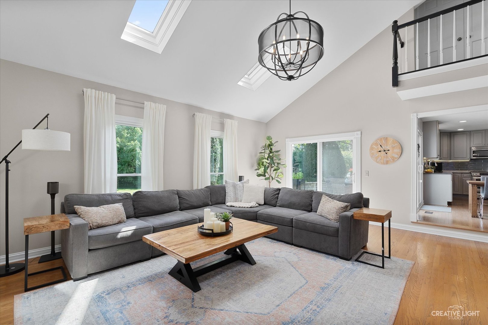 409 Flock Avenue Naperville, IL 60565 - Photo 16 of 48 a living room with furniture a chandelier and a window
