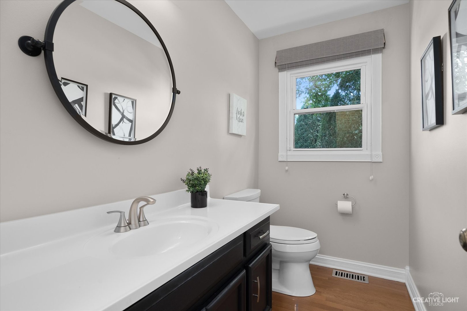 409 Flock Avenue Naperville, IL 60565 - Photo 18 of 48 a bathroom with a toilet a sink a mirror and a window