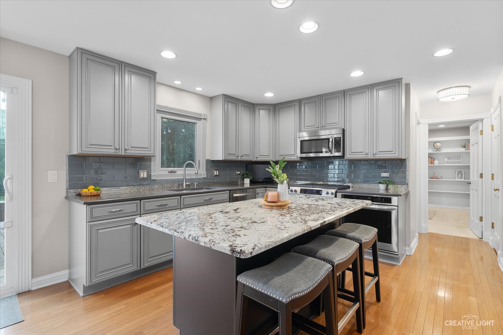 409 Flock Avenue Naperville, IL 60565 - Photo 8 of 48 a kitchen with a stove a refrigerator and a counter top space