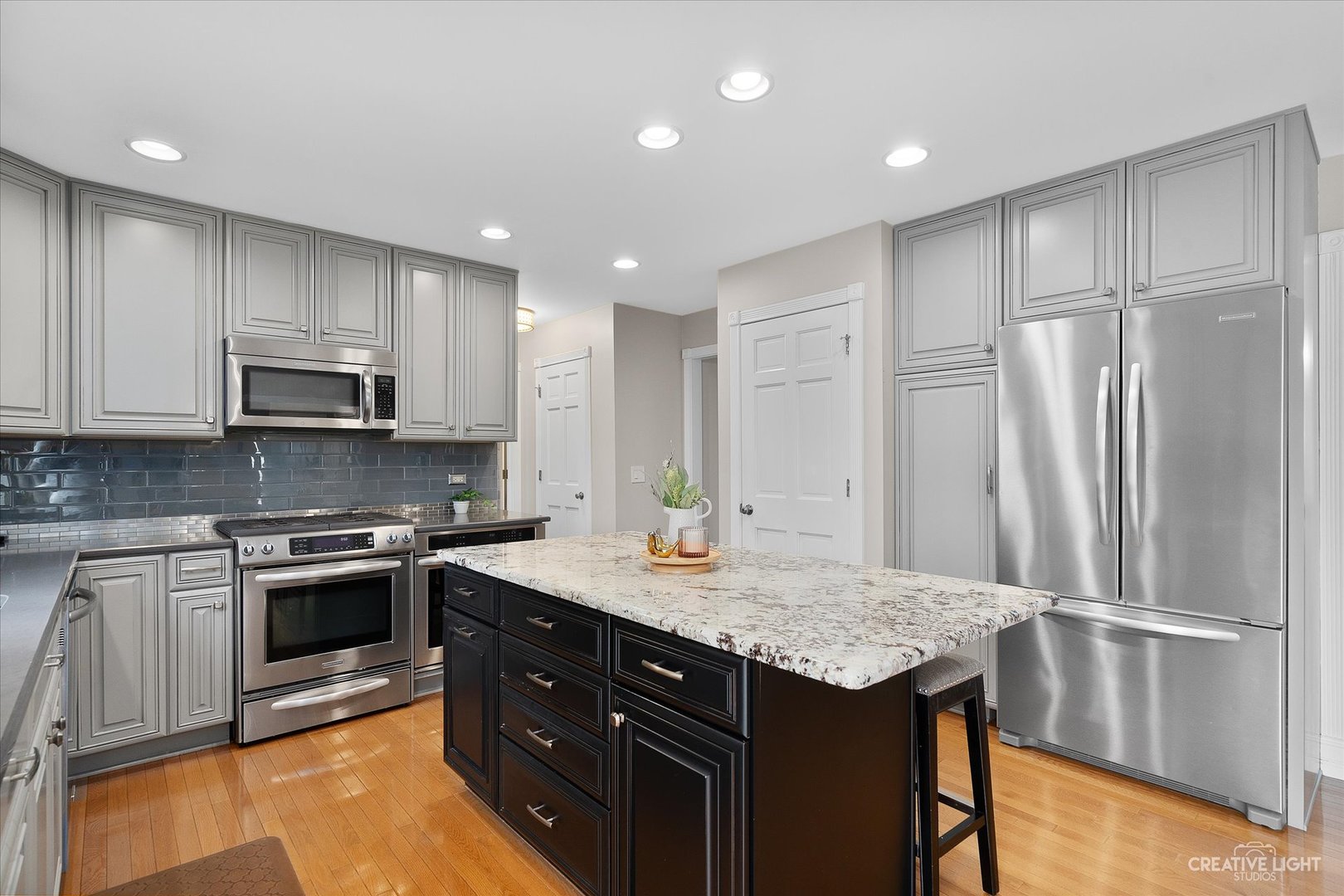 409 Flock Avenue Naperville, IL 60565 - Photo 9 of 48 a kitchen with stainless steel appliances granite countertop a sink stove and refrigerator
