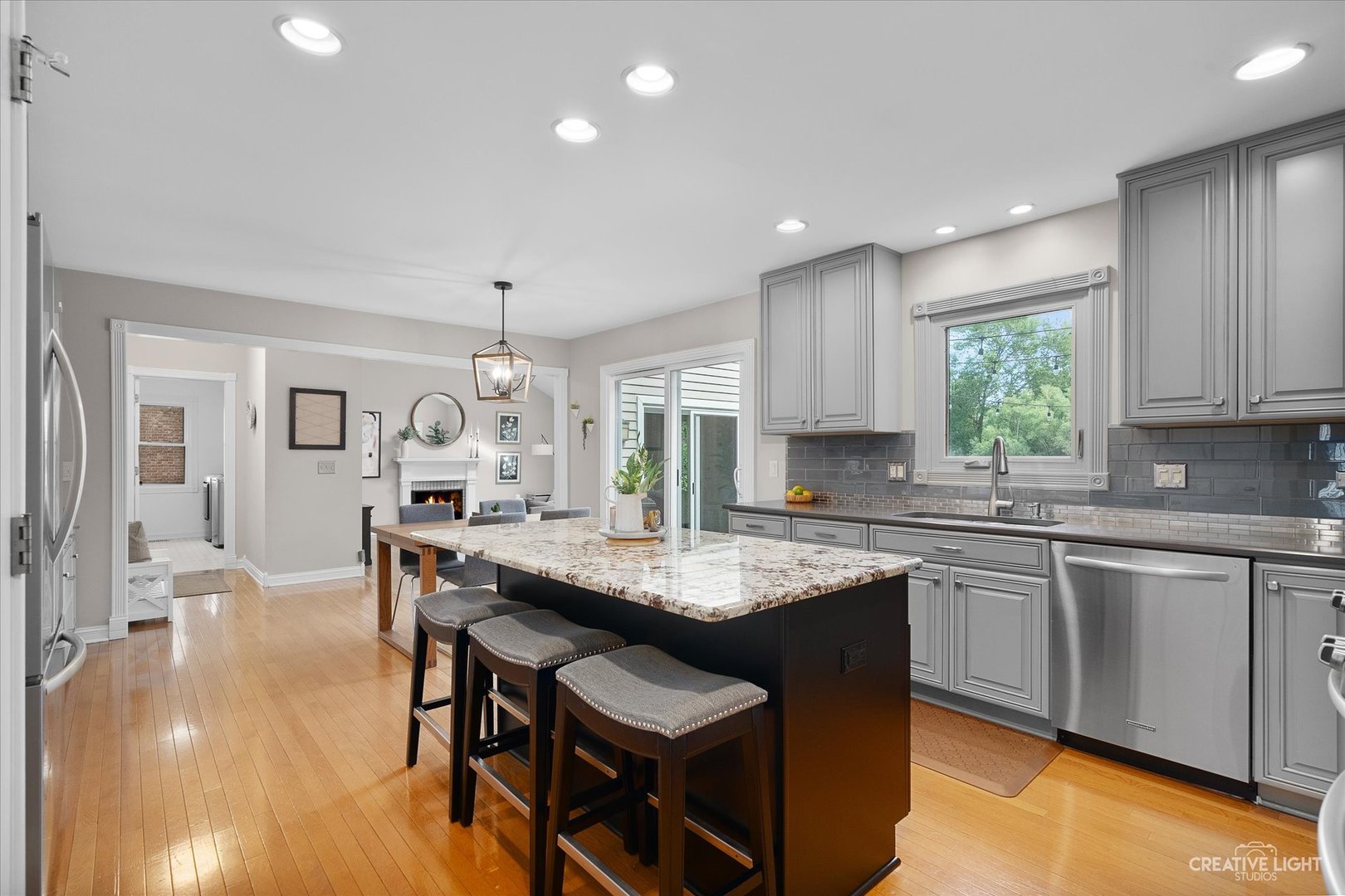 409 Flock Avenue Naperville, IL 60565 - Photo 10 of 48 a kitchen with granite countertop kitchen island white cabinets and stainless steel appliances