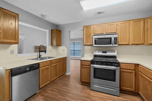 a kitchen with a stove and a sink