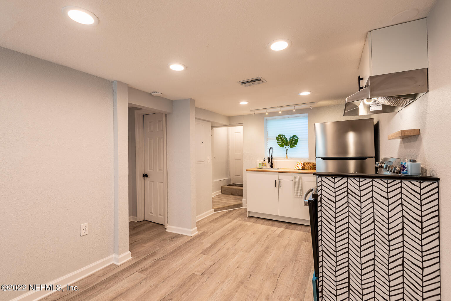 5150 107th Street Jacksonville, FL 32244 - Photo 11 of 43 a large kitchen with a lot of counter space and a wooden floor