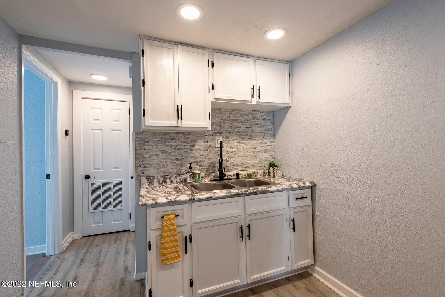 5150 107th Street Jacksonville, FL 32244 - Photo 24 of 43 a bathroom with a sink a vanity and mirror