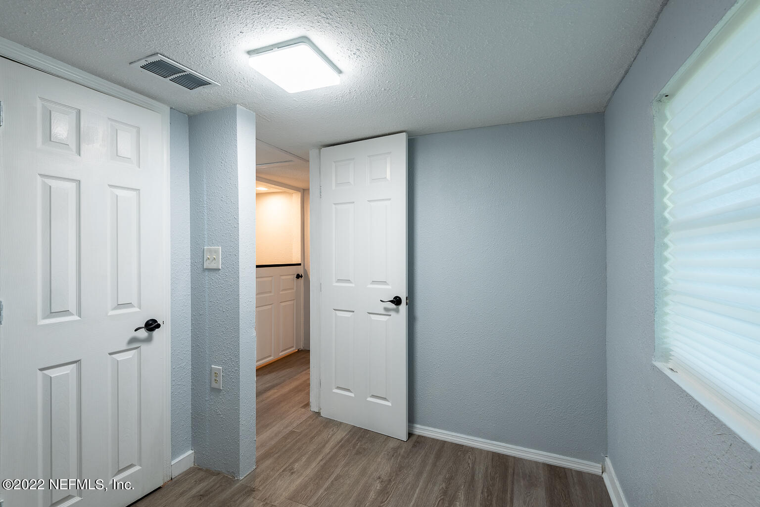 5150 107th Street Jacksonville, FL 32244 - Photo 43 of 43 a view of a hallway with wooden floor and closet area