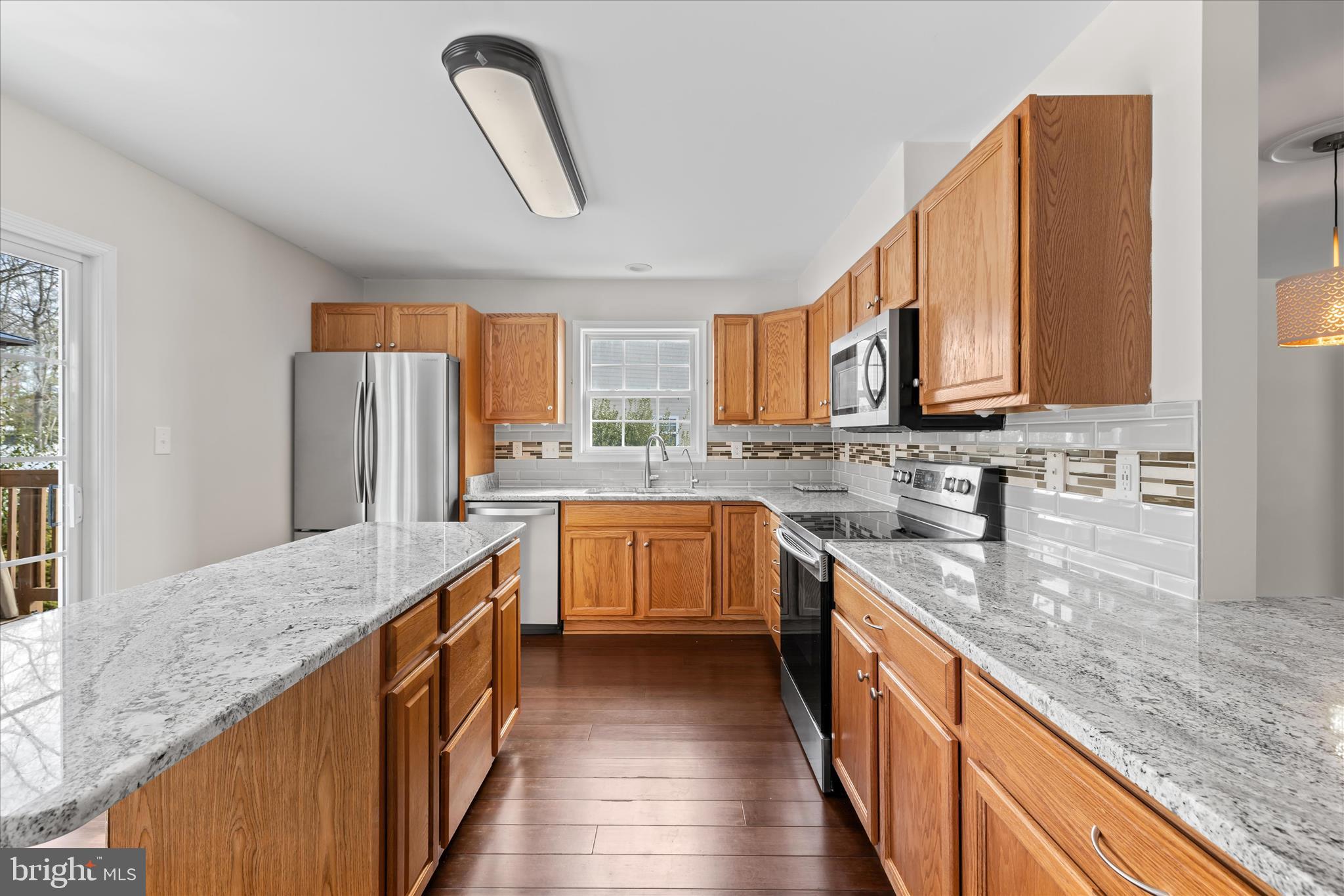 19095 Carey Lane Georgetown, DE 19947 - Photo 12 of 39 a kitchen with stainless steel appliances granite countertop a stove a sink a refrigerator and island