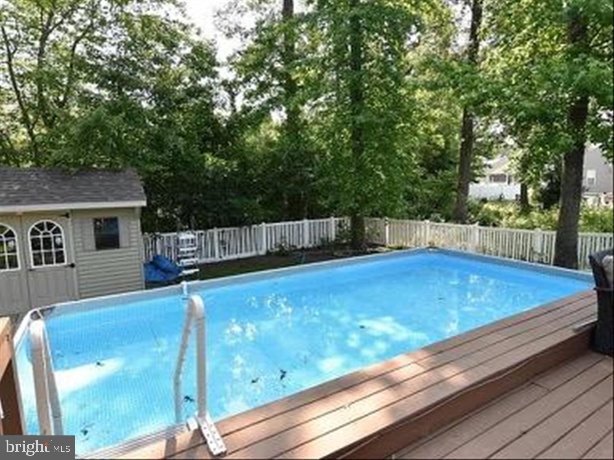19095 Carey Lane Georgetown, DE 19947 - Photo 15 of 39 a view of a backyard with a large tree and wooden fence
