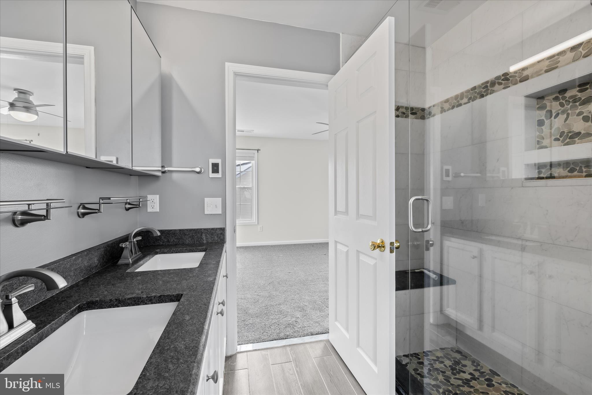 19095 Carey Lane Georgetown, DE 19947 - Photo 21 of 39 a kitchen with granite countertop a refrigerator a sink and white cabinets