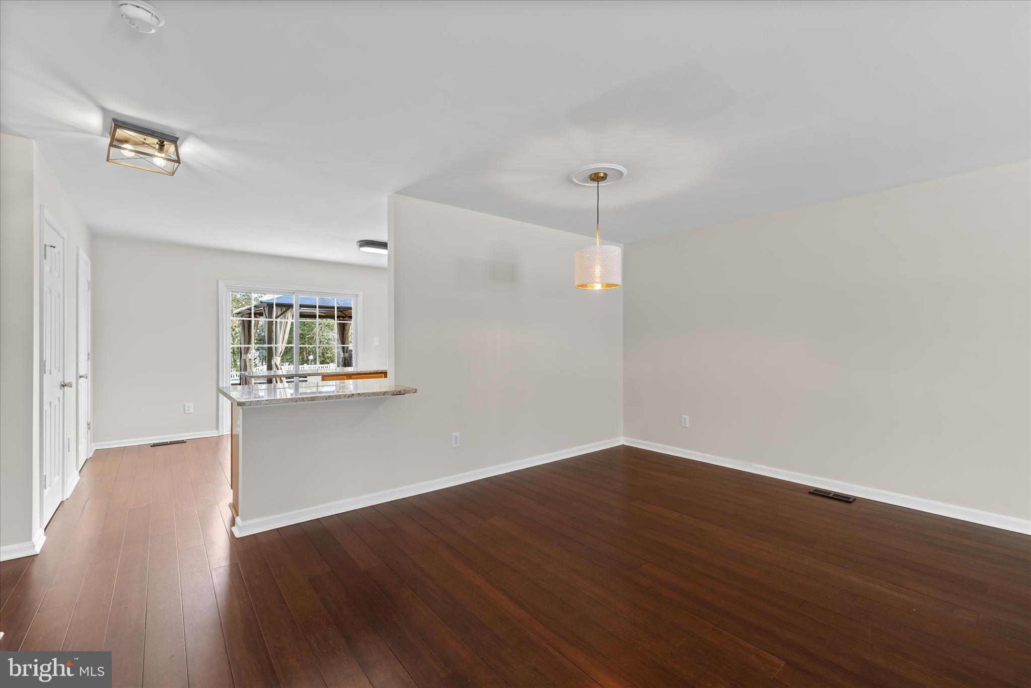19095 Carey Lane Georgetown, DE 19947 - Photo 7 of 39 an empty room with wooden floor and windows