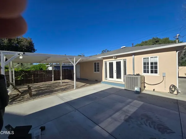 a view of a house with backyard and porch