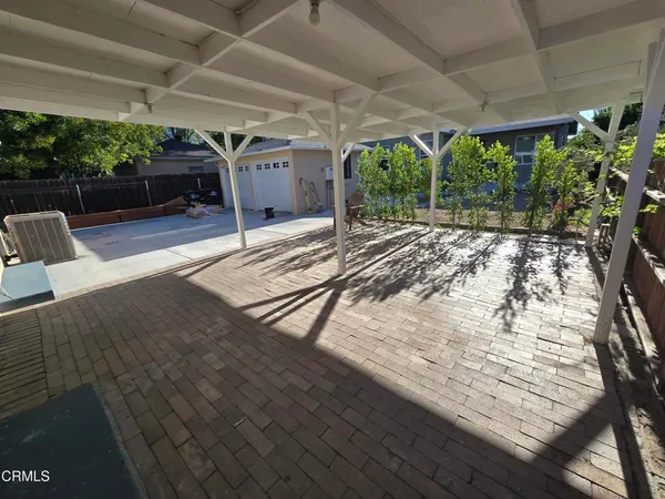 a view of a backyard with seating space