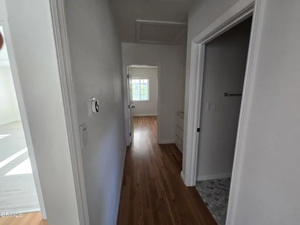 a view of a hallway with wooden floor