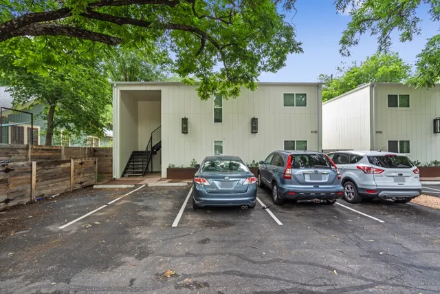 a car parked in front of white house