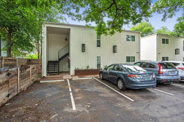 a car parked in front of white house