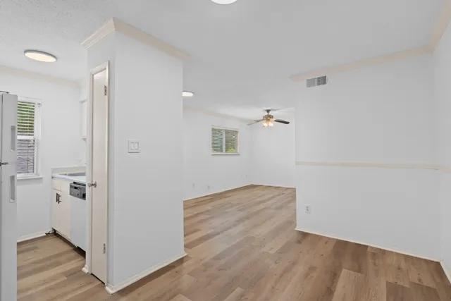 a view of empty room with wooden floor