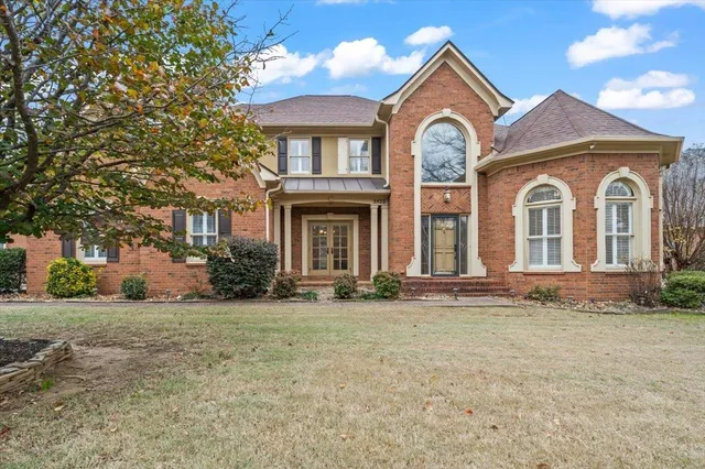 a front view of a house with a garden