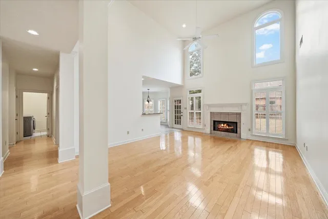a view of empty room with fireplace and wooden floor