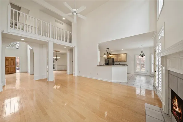 a view of a big room with kitchen view and a fireplace