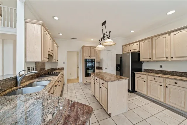 a kitchen with granite countertop a sink stainless steel appliances and white cabinets