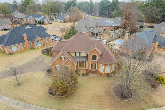 an aerial view of a house with a yard