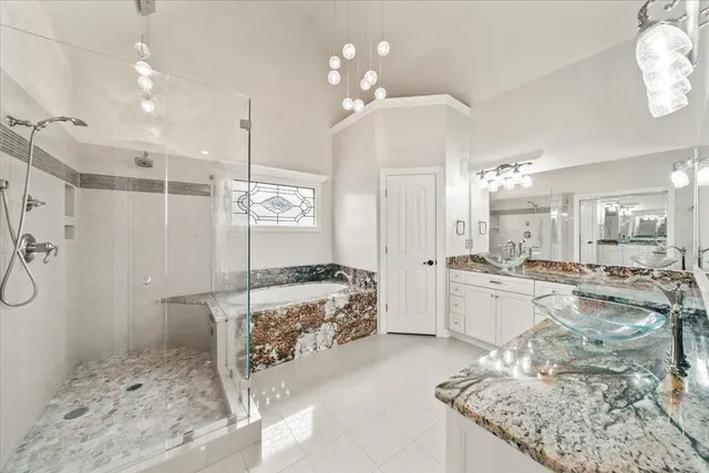 a large bathroom with a tub sink and shower