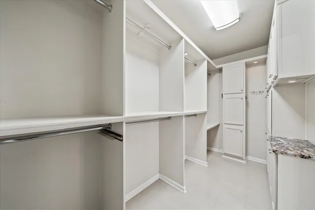 a view of walk in closet with empty racks