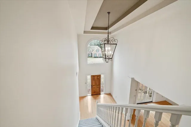 a view of a hallway view with wooden floor and staircase