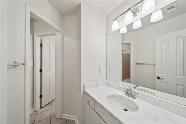 a bathroom with a sink vanity granite shower and a mirror