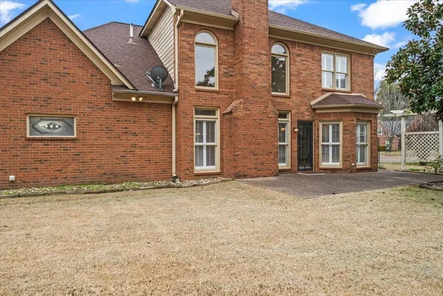 a view of a brick house with many windows