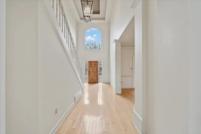 a view of a hallway with wooden floor and staircase